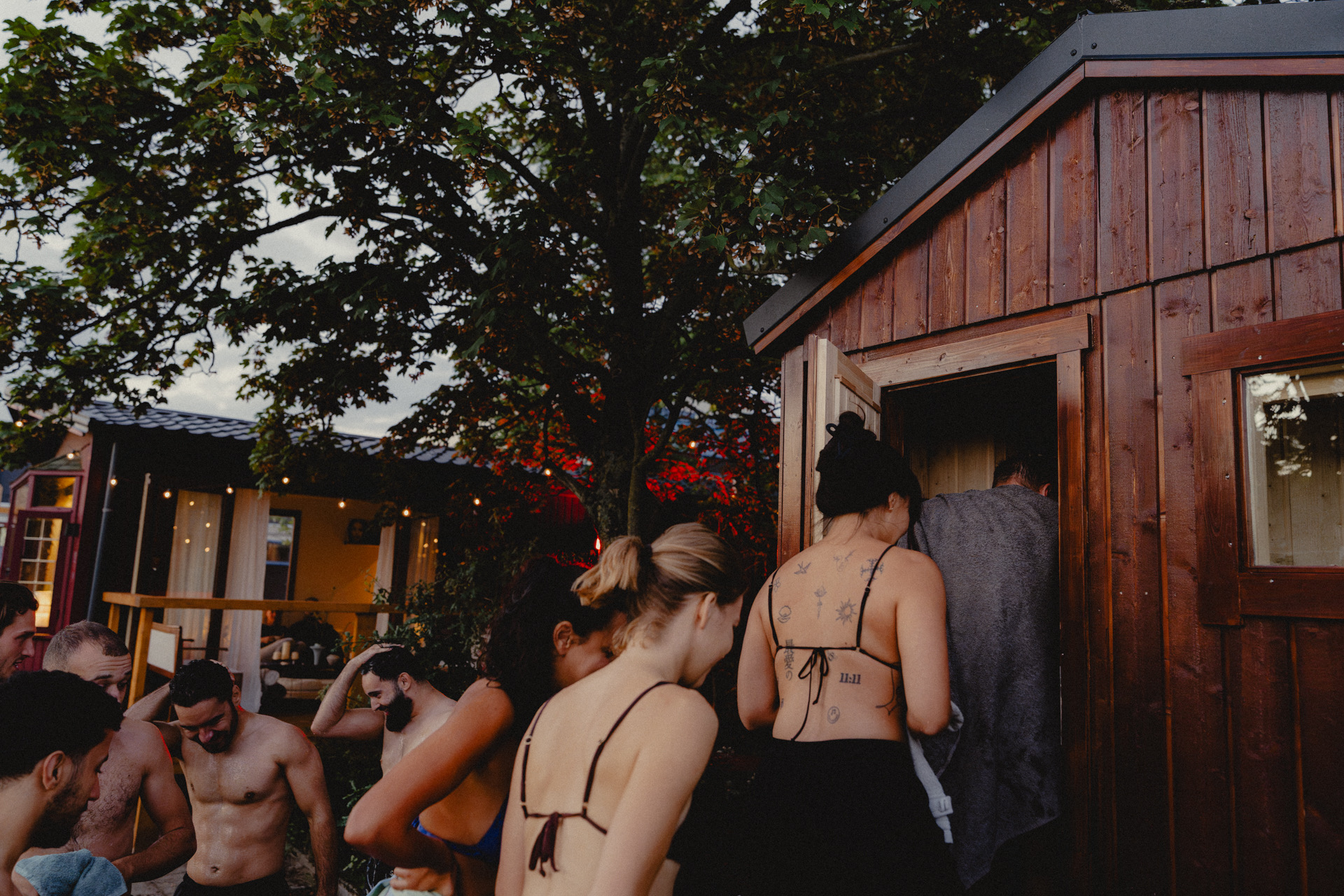Guests gathering outside the SOKI sauna at dusk